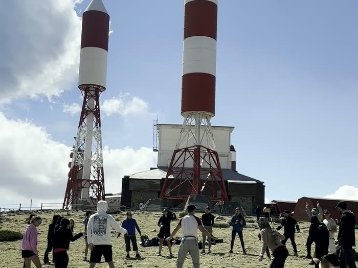 Un juego en corro bajo las antenas de la cima
