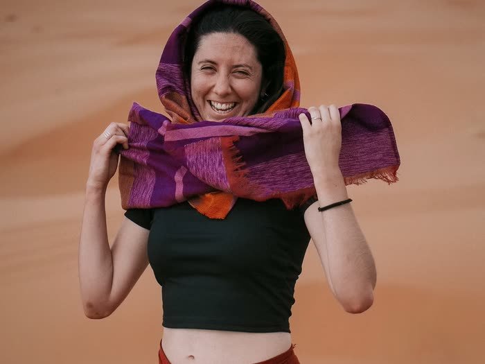 Una chica riéndose con un pañuelo en la cabeza
